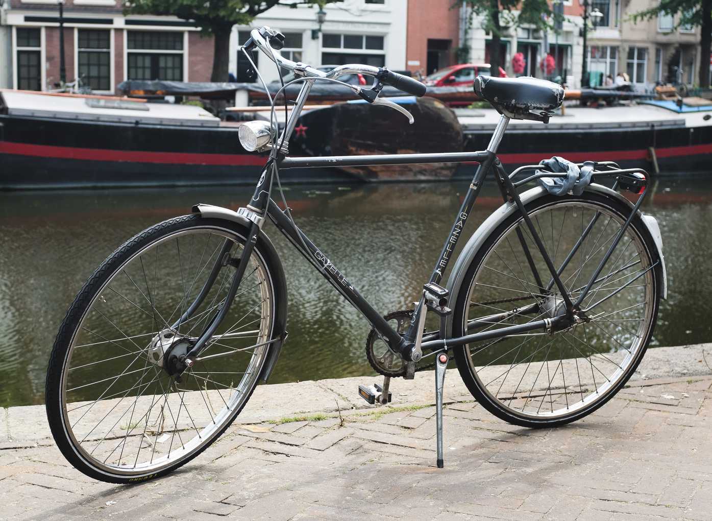 Gray bicycle alongside a canal