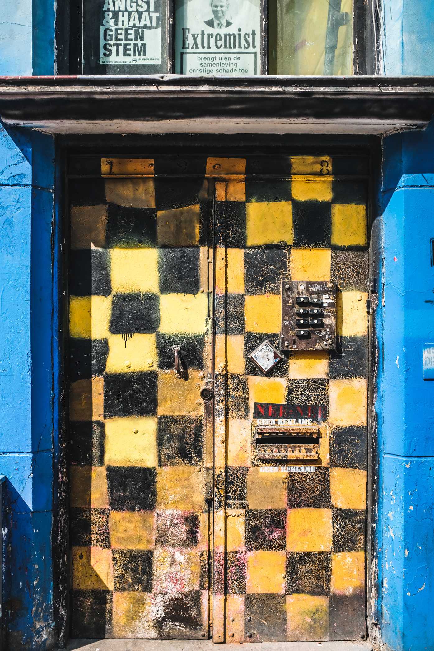 A door with a yellow-and-black checkboard pattern