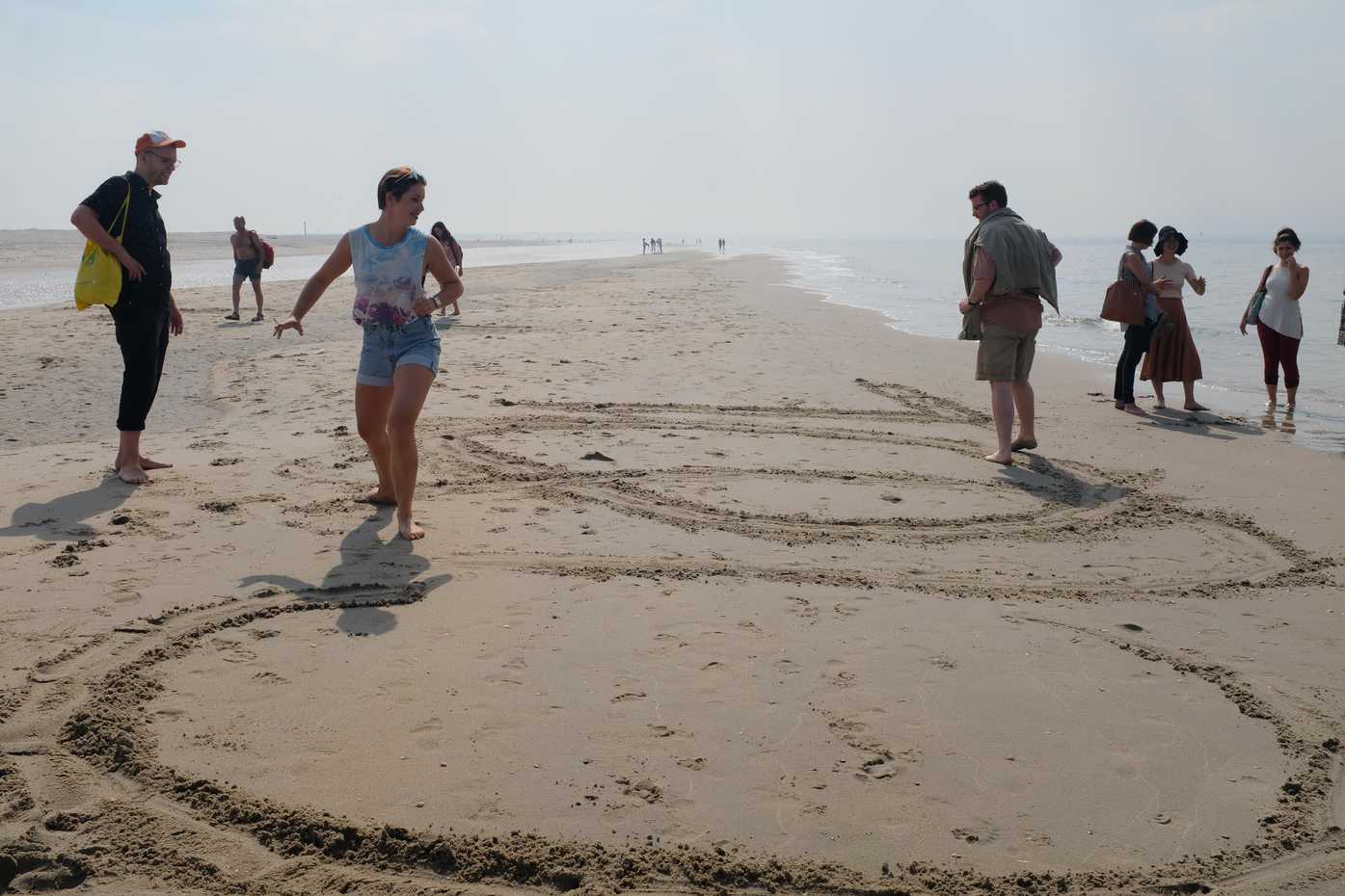 Drawing big letters in the sand. Cool.